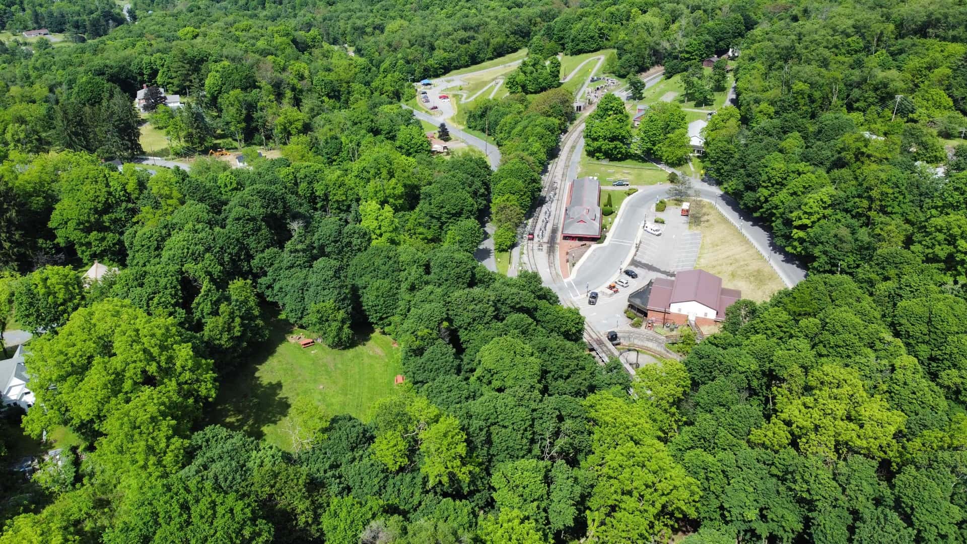 Aerial view of The Tunnel Hotel property and campground beside the rails in Frostburg, Maryland, available for whole-property private bookings